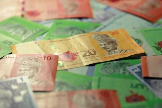 Ringgit eases against the dollar